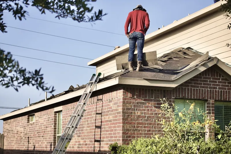 Professional roofer working on a residential roof in Grayson